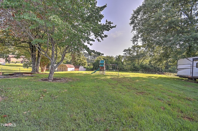 112 Hillview Rd, Kingsport, TN 37664 - view of grassy yard featuring a storage unit and a playground