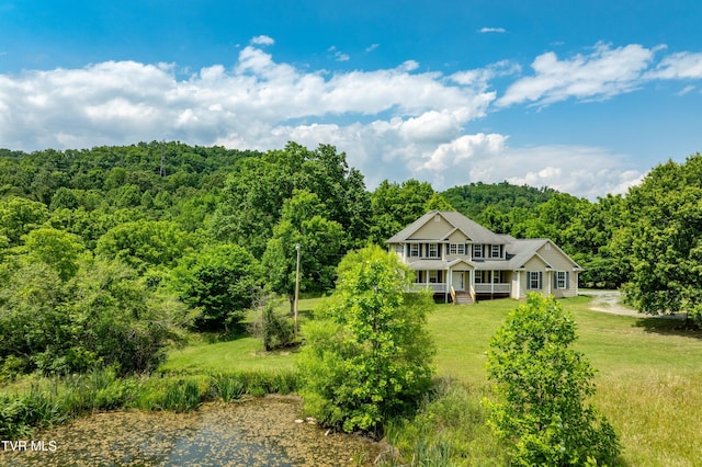 2898 Watauga Rd, Johnson City, TN 37601 - rear view of house featuring a wooded view, a porch, and a lawn