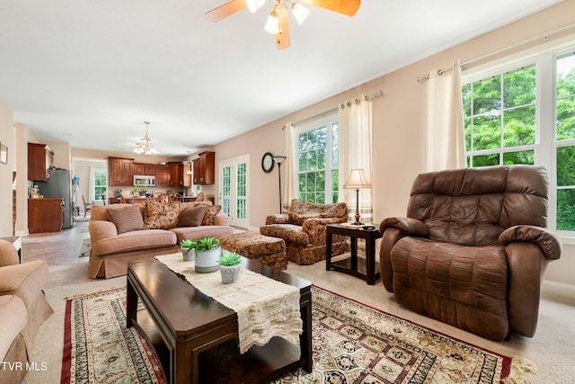 2898 Watauga Rd, Johnson City, TN 37601 - living room featuring a ceiling fan, a chandelier, and baseboards