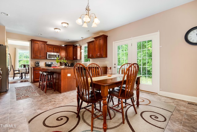 2898 Watauga Rd, Johnson City, TN 37601 - dining area featuring healthy amount of natural light, a chandelier, and baseboards