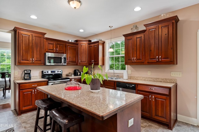 2898 Watauga Rd, Johnson City, TN 37601 - kitchen featuring stainless steel appliances, a sink, a breakfast bar area, pendant lighting, and a kitchen island