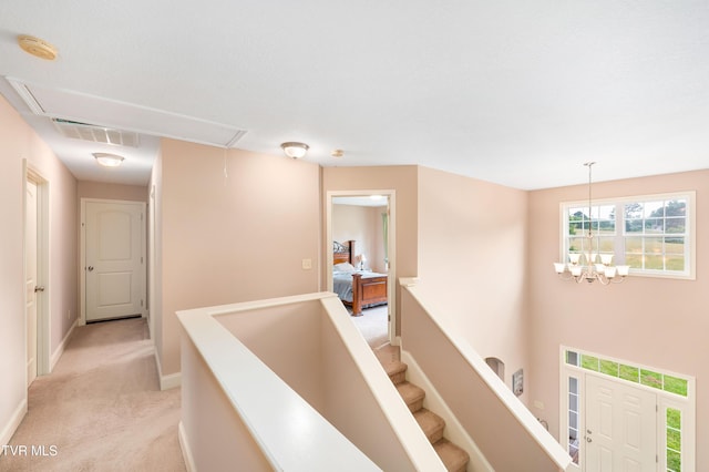 2898 Watauga Rd, Johnson City, TN 37601 - hallway with attic access, light colored carpet, baseboards, and a chandelier