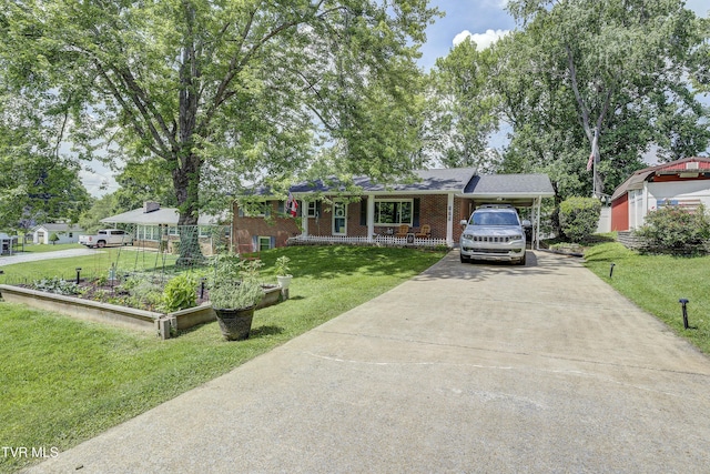 175 Shenandoah Dr, Johnson City, TN 37601 - view of front of house with driveway, a front lawn, brick siding, a porch, and an attached carport