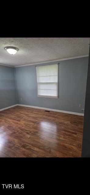 15266 Spring Valley Rd, Abingdon, VA 24210 - spare room with wood finished floors, baseboards, a textured ceiling, and crown molding