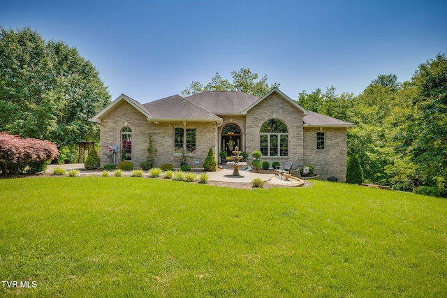 100 Pointe Dr, Piney Flats, TN 37686 - view of front facade with a front yard, a shingled roof, and brick siding