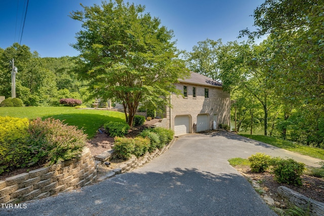 100 Pointe Dr, Piney Flats, TN 37686 - view of front of house featuring driveway, an attached garage, and a front lawn