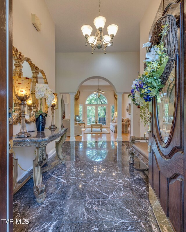 100 Pointe Dr, Piney Flats, TN 37686 - foyer with arched walkways, ornate columns, french doors, a chandelier, and marble tiled floors