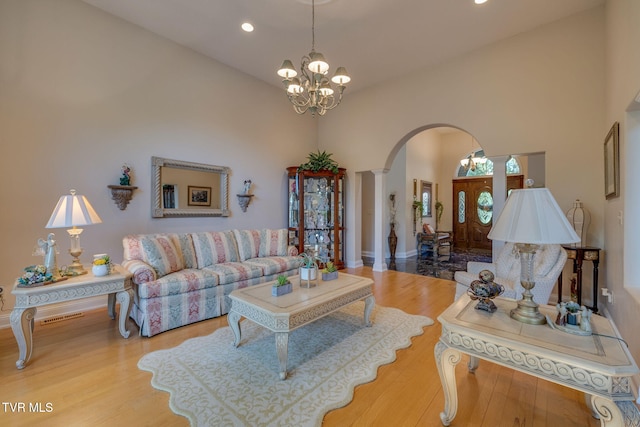100 Pointe Dr, Piney Flats, TN 37686 - living area featuring arched walkways, a chandelier, recessed lighting, wood finished floors, and a high ceiling