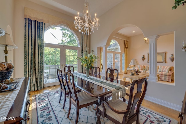 100 Pointe Dr, Piney Flats, TN 37686 - dining area with french doors, arched walkways, light wood-style floors, a chandelier, and decorative columns