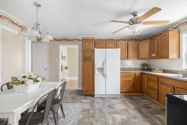 2012 Euclid Ave, Bristol, VA 24201 - kitchen featuring white refrigerator with ice dispenser, brown cabinetry, stove, a chandelier, and ceiling fan