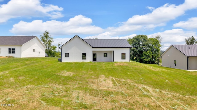 1930 Erwin Hwy, Greeneville, TN 37745 - rear view of property featuring a yard, a pole building, a metal roof, and an outbuilding