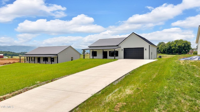 1930 Erwin Hwy, Greeneville, TN 37745 - modern farmhouse featuring an attached garage, a mountain view, a front yard, concrete driveway, and a metal roof