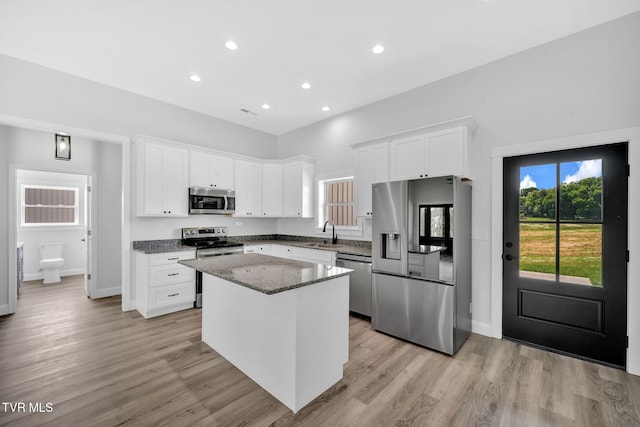 1930 Erwin Hwy, Greeneville, TN 37745 - kitchen featuring appliances with stainless steel finishes, a kitchen island, white cabinets, dark stone countertops, and recessed lighting