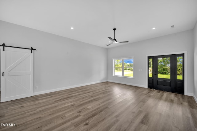 1930 Erwin Hwy, Greeneville, TN 37745 - unfurnished living room featuring ceiling fan, wood finished floors, recessed lighting, and a barn door