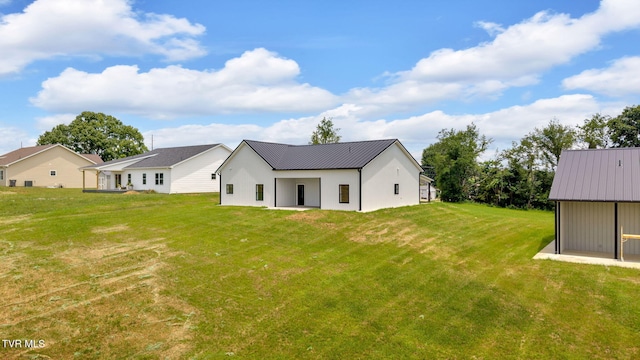 1930 Erwin Hwy, Greeneville, TN 37745 - back of house featuring a yard, a metal roof, and stucco siding