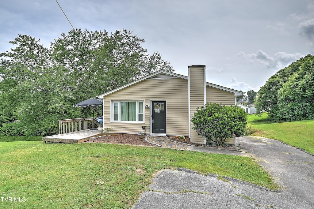 1026 Clark St, Bristol, VA 24201 - view of front of home featuring a front lawn, a deck, and a chimney