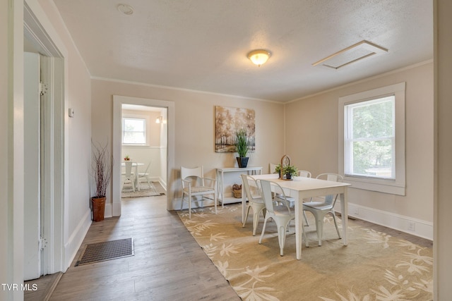 645 Suffolk Ave, Bristol, VA 24201 - dining area with light wood-style flooring, crown molding, baseboards, and attic access