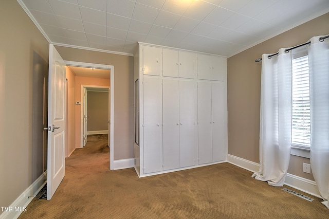 1241 Carolina Ave, Bristol, TN 37620 - unfurnished bedroom featuring carpet flooring, crown molding, a closet, and baseboards