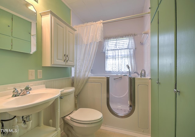 1241 Carolina Ave, Bristol, TN 37620 - full bath with toilet, shower / bathtub combination with curtain, and a wainscoted wall