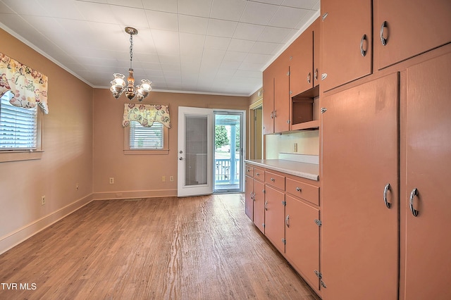 1241 Carolina Ave, Bristol, TN 37620 - kitchen with ornamental molding, light wood-style flooring, light countertops, a chandelier, and baseboards