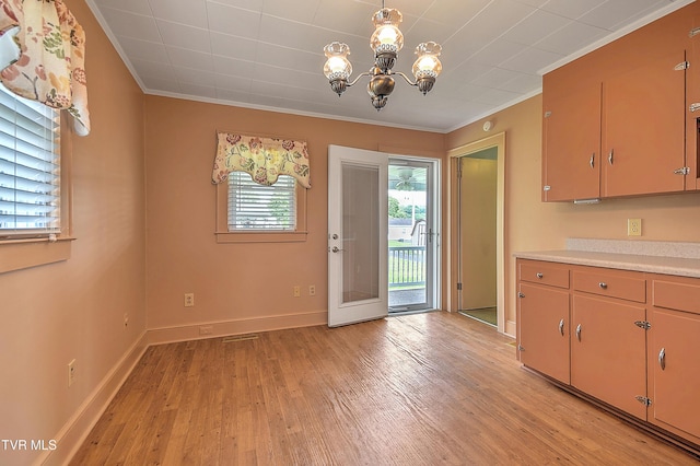 1241 Carolina Ave, Bristol, TN 37620 - kitchen with ornamental molding, light countertops, light wood-style floors, a chandelier, and baseboards
