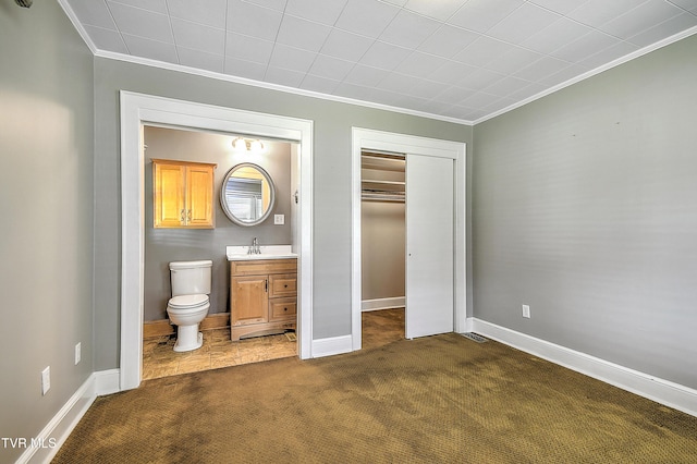 1241 Carolina Ave, Bristol, TN 37620 - bedroom featuring ornamental molding, dark carpet, ensuite bathroom, a closet, and baseboards