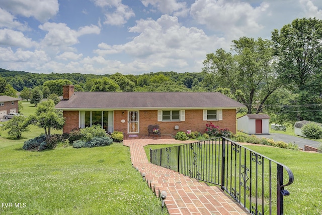 296 Redstone Dr, Bluff City, TN 37618 - single story home featuring a chimney, brick siding, a front lawn, a wooded view, and roof with shingles