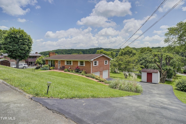 296 Redstone Dr, Bluff City, TN 37618 - single story home with a chimney, brick siding, asphalt driveway, a front yard, and an attached garage
