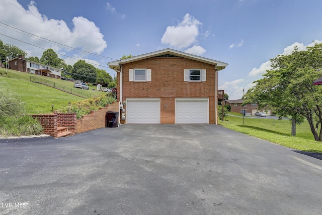 296 Redstone Dr, Bluff City, TN 37618 - view of side of property with asphalt driveway, a garage, brick siding, and a lawn