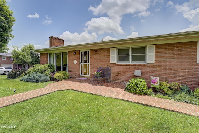 296 Redstone Dr, Bluff City, TN 37618 - ranch-style home featuring a chimney, a front lawn, and brick siding