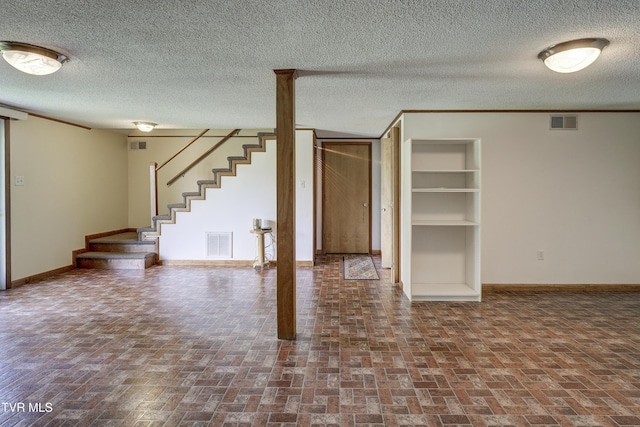 296 Redstone Dr, Bluff City, TN 37618 - unfurnished living room with brick patterned flooring, baseboards, stairway, and a textured ceiling