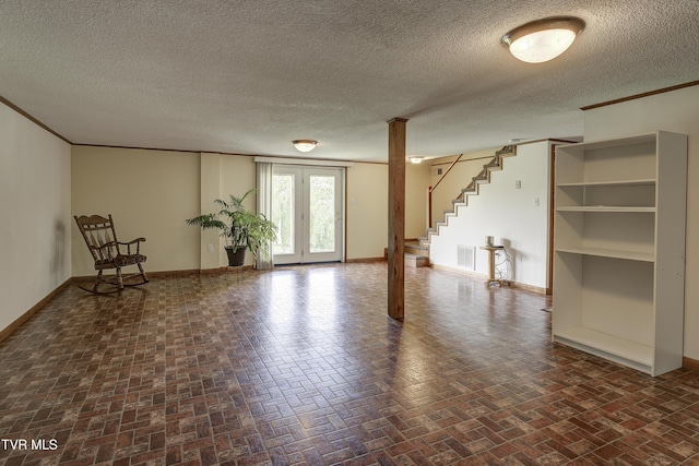 296 Redstone Dr, Bluff City, TN 37618 - unfurnished room featuring baseboards, brick patterned floors, stairs, a textured ceiling, and crown molding