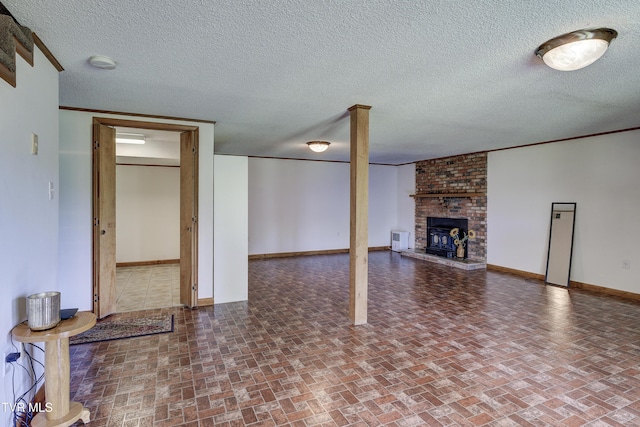 296 Redstone Dr, Bluff City, TN 37618 - unfurnished living room featuring baseboards, brick patterned floors, a brick fireplace, and a textured ceiling