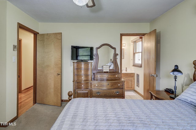 296 Redstone Dr, Bluff City, TN 37618 - bedroom with light carpet, ensuite bath, ceiling fan, and baseboards