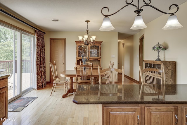 296 Redstone Dr, Bluff City, TN 37618 - dining room featuring light wood finished floors, a chandelier, and baseboards