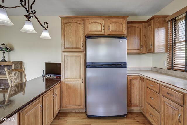 296 Redstone Dr, Bluff City, TN 37618 - kitchen featuring freestanding refrigerator, light wood-style floors, and pendant lighting