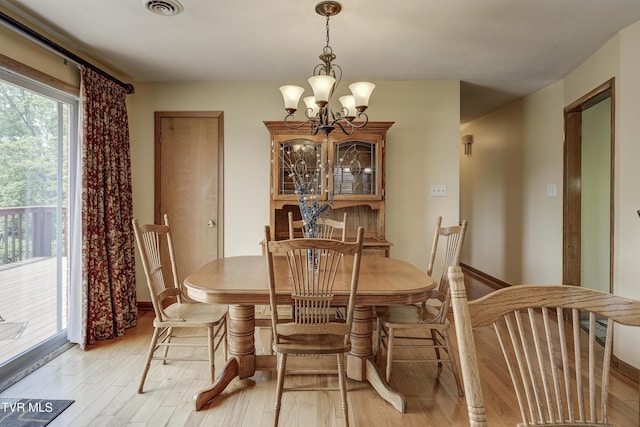 296 Redstone Dr, Bluff City, TN 37618 - dining area with a chandelier, light wood-style flooring, and baseboards