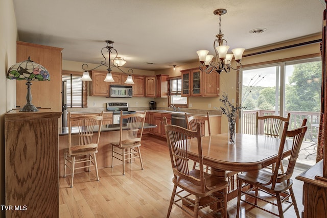 296 Redstone Dr, Bluff City, TN 37618 - dining area featuring a chandelier and light wood-style flooring