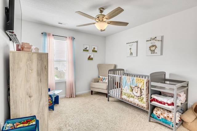 1058 Raccoon Ln, Piney Flats, TN 37686 - carpeted bedroom with a crib, baseboards, and ceiling fan