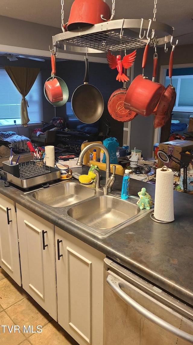 1315 Lowe St, Elizabethton, TN 37643 - kitchen with dishwasher, a sink, white cabinets, and dark countertops