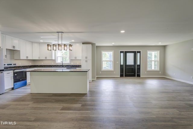 1105 Laurel Way, Mountain City, TN 37683 - kitchen featuring stainless steel stove, dark countertops, a kitchen island, open floor plan, and a sink