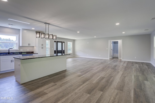 1105 Laurel Way, Mountain City, TN 37683 - kitchen featuring a sink, a center island, white cabinets, recessed lighting, and wood finished floors