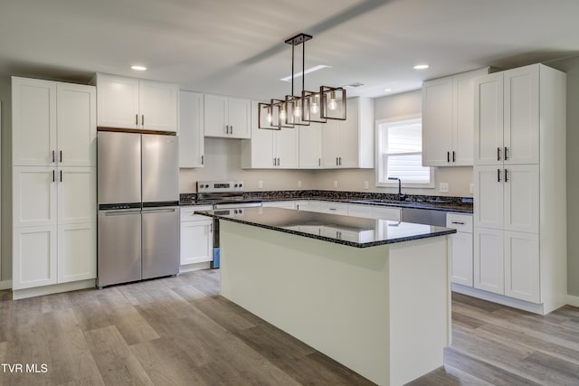 1105 Laurel Way, Mountain City, TN 37683 - kitchen with appliances with stainless steel finishes, light wood finished floors, white cabinetry, a sink, and recessed lighting