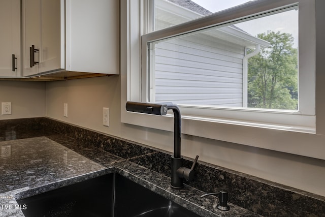 1105 Laurel Way, Mountain City, TN 37683 - kitchen view of a sink, white cabinetry, and dark stone countertops