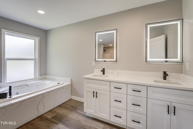 1105 Laurel Way, Mountain City, TN 37683 - bathroom with double vanity, wood finished floors, a jetted tub, recessed lighting, and baseboards