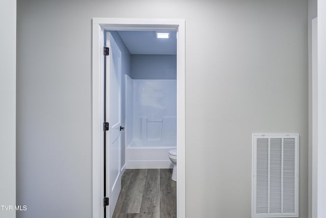 1105 Laurel Way, Mountain City, TN 37683 - full bathroom with toilet, wood finished floors, and shower / washtub combination