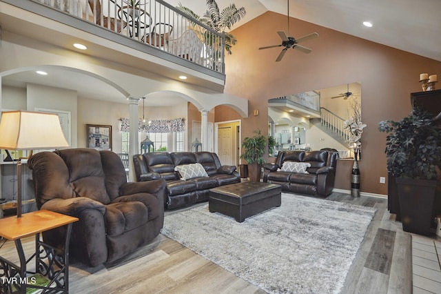 17308 Crabtree Ct, Bristol, VA 24202 - living area featuring decorative columns, arched walkways, ceiling fan, wood finished floors, and high vaulted ceiling