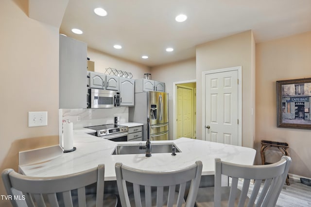17308 Crabtree Ct, Bristol, VA 24202 - kitchen featuring stainless steel appliances, gray cabinetry, a peninsula, a breakfast bar area, and recessed lighting