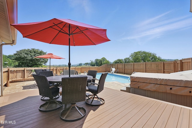 17308 Crabtree Ct, Bristol, VA 24202 - wooden deck with a fenced backyard, outdoor dining space, and a covered hot tub