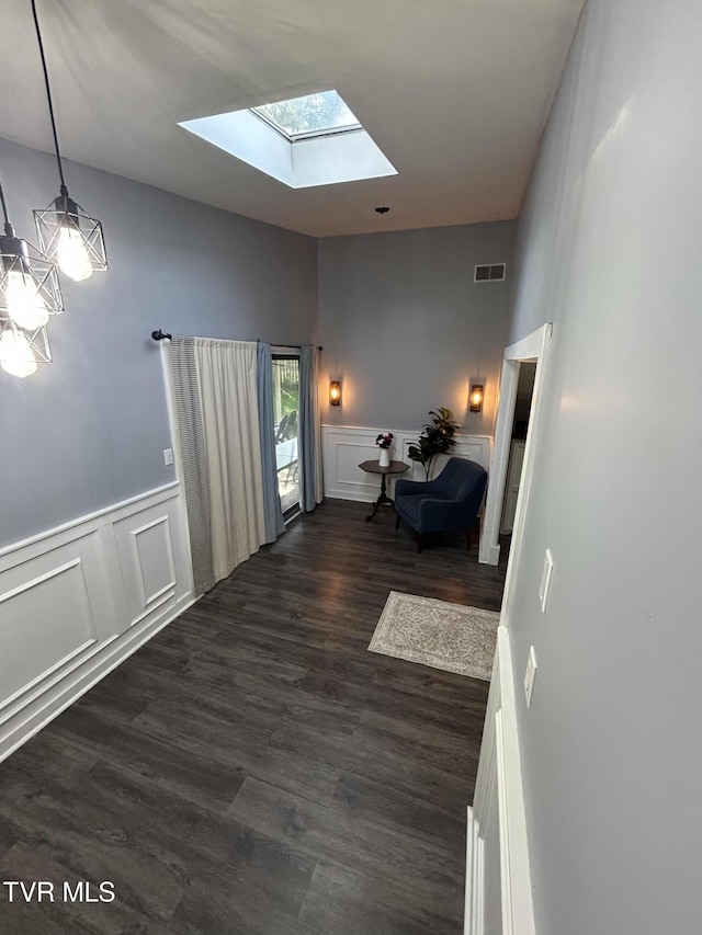 172 Dakota Rd, Bristol, VA 24201 - bedroom featuring a skylight, a decorative wall, dark wood-type flooring, a wainscoted wall, and a chandelier